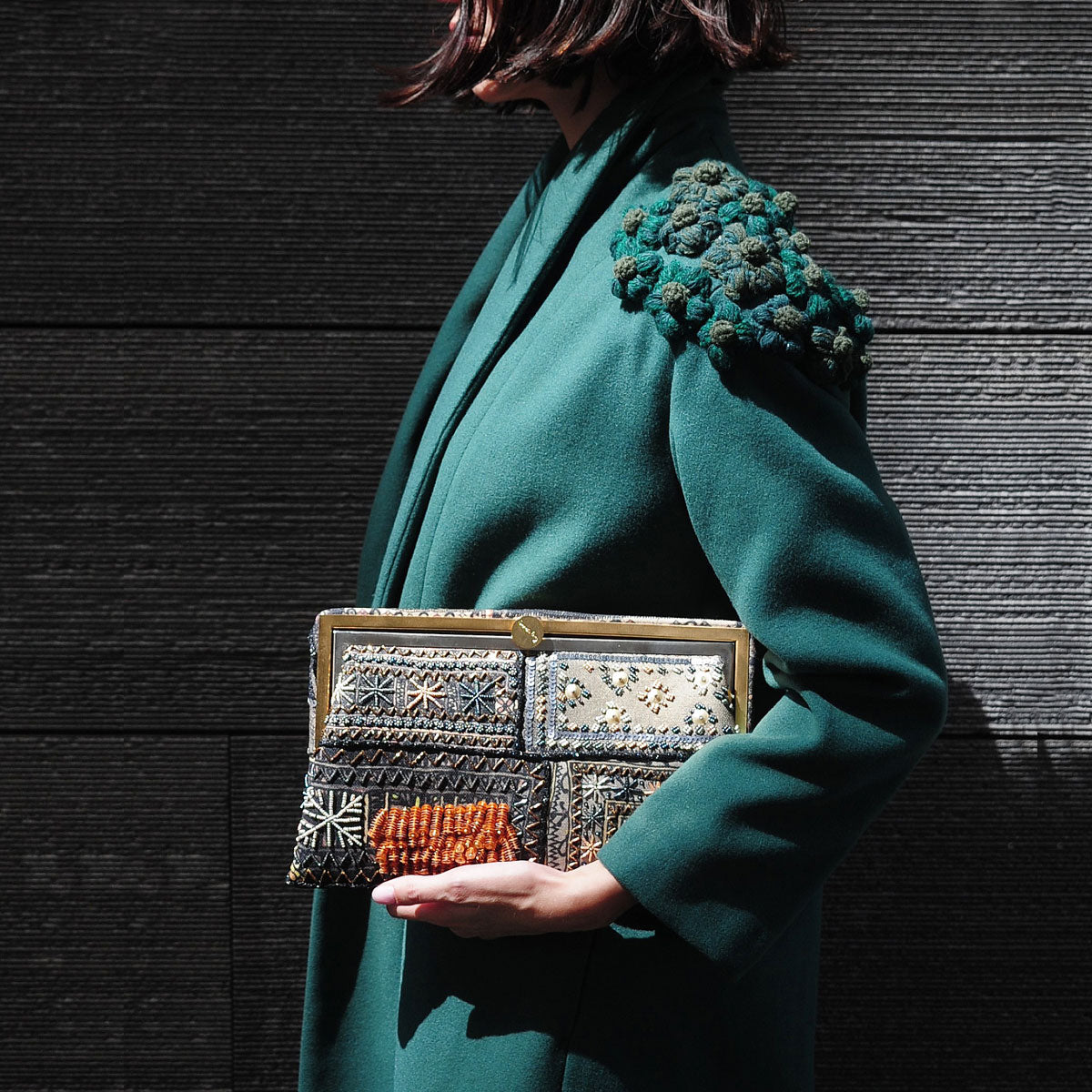 bedouin metallic grace clutch bag on model