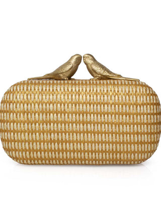 Gold straw clutch with two birds kissing clasp decorations on a white background