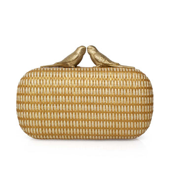 Gold straw clutch with two birds kissing clasp decorations on a white background