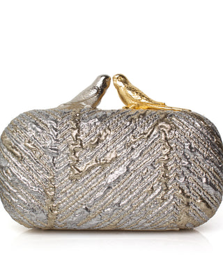 Silver and gold metallic clutch bag topped with two birds one silver and one gold on a white background