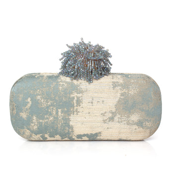 Clutch bag with textured surface and dhalia clasp  on a white background