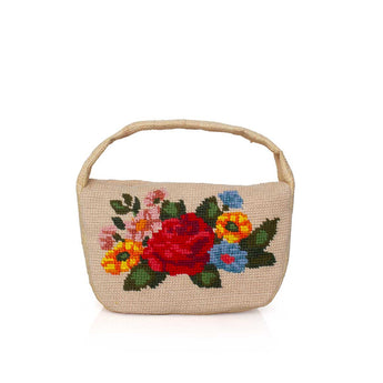 Woven handbag with colorful floral embroidery on a white background