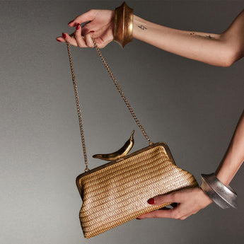 chili gold straw classic clutch bag with shoulder chain on model