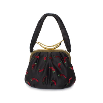 A black handbag with a pattern of red chili peppers and green leaves, featuring a gold-colored metal clasp and black straps.