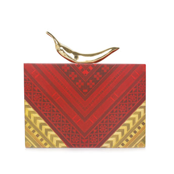 A red and wood geometric patterned bag with a gold clasp in the shape of a chili pepper.
