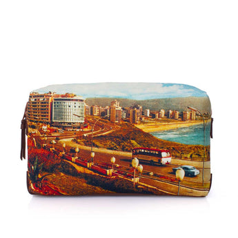 A zippered cosmetic pouch featuring a colorful printed scenic photograph of a coastal city with buildings, a highway, streetlights, and a beach, shown against a plain white background.