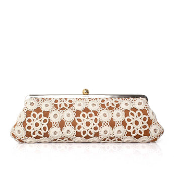White crocheted clutch bag on havane with a gold clasp on a white background