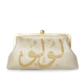 A gold-colored customized bag with Arabic calligraphy hand-embroidered with gold beads on the front.