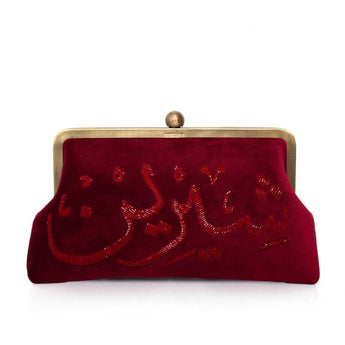 Burgundy velvet clutch bag with beaded calligraphy with burgundy beads accents on a white background