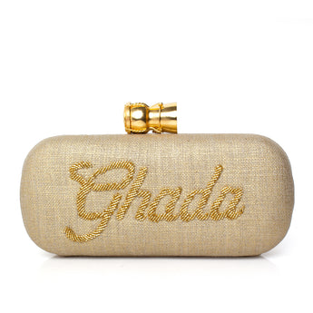 Gold clutch bag with calligraphy name  embroidery and a champagne buckle on a white background