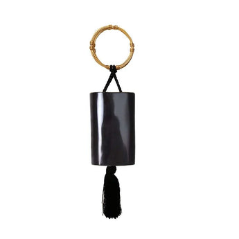 A black lacquered wristlet with a glossy finish and a black tassel, featuring twin gold bracelet handles.