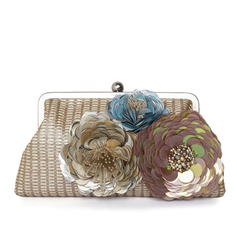 A straw handbag with floral embellishments in pastel colors.