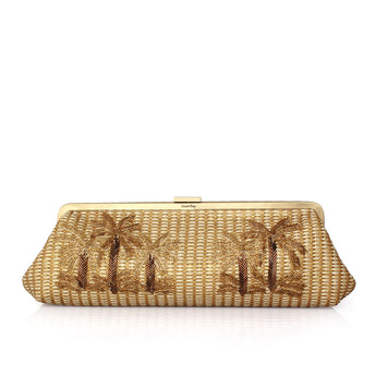 A gold-toned straw clutch bag with embroidered palm tree motifs, a gold-tone metal frame, and a small 'Lindy' brand mark at the top center, shown on a clean white background.