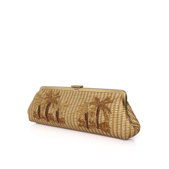 A gold straw clutch bag with embroidered palm tree motifs, featuring a gold-tone metal frame closure, set against a plain white background.