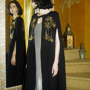 Black imperial cape on model embroidered with gold palms