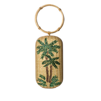 A straw gold straw bag with a palm tree motif and green glass beads, featuring twin gold bracelet handles.
