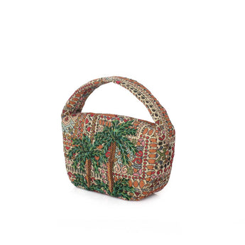 A small structured handbag with a curved top handle, featuring an intricate multicolor pattern of green palm trees, red and orange motifs, and beige background details.