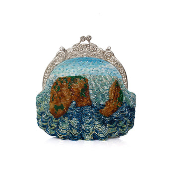A beaded clutch purse featuring a landscape design with blue and green waves and brown cliffs under a silver-tone ornate metal clasp frame, set against a plain white background.