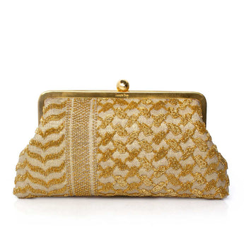 Gold keffiyeh patterned clutch bag on a white background