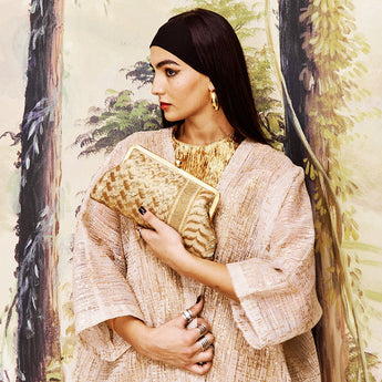 Gold keffiyeh patterned clutch bag on a white background