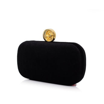 Black clutch with a gold moon clasp on a white background