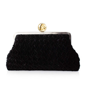 Black velvet clutch with a moon gold clasp on a white background