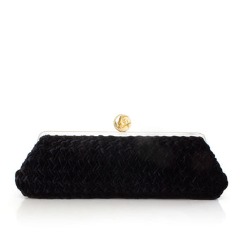 Black long velvet clutch with a gold clasp on a white background