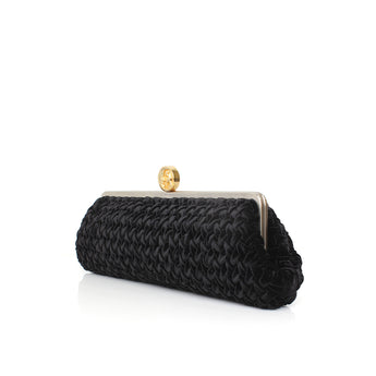 Black long velvet clutch with a gold clasp on a white background