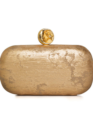 Gold clutch with a moon design clasp on a white background