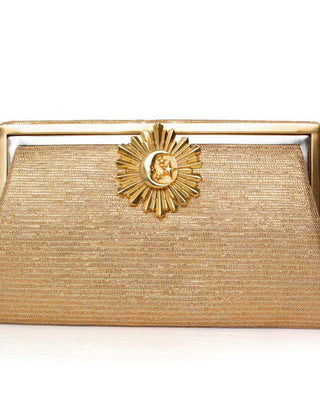 Gold clutch bag with a decorative moon rays clasp on a white background