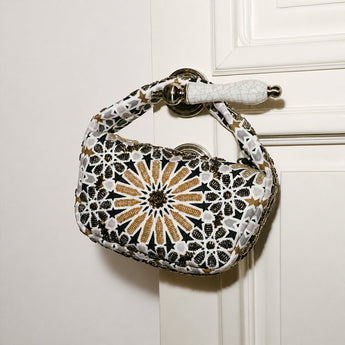 Decorative handbag with Moroccan pattern on a white door