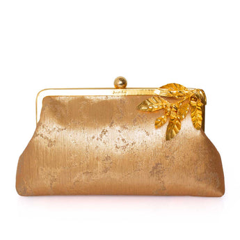 Gold clutch purse with leaf detail on a white background