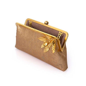 Gold clutch purse with leaf design on a white background