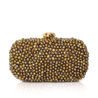A beaded evening clutch bag covered in small iridescent pearls in gold, bronze, and brown tones, featuring a faceted gold diamond shape clasp on a white background with a soft reflection.