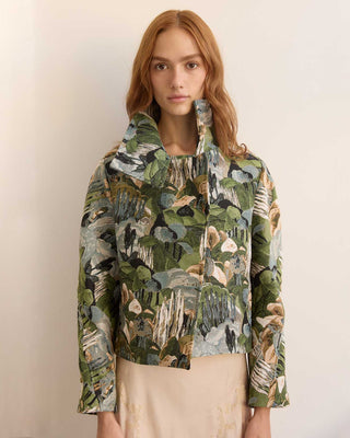 Woman wearing a pine forest jacket against a plain background