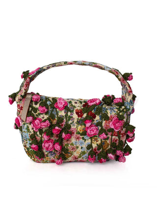 Floral patterned with crocheted pink roses handbag on a white background