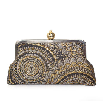 Elegant clutch bag with sunburst gold and black pattern on a white background