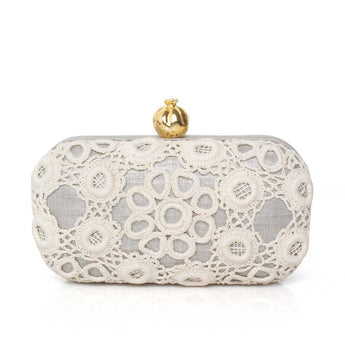 White crocheted clutch bag with a gold clasp on a white background