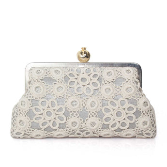White crocheted clutch bag with a gold clasp on a white background