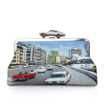 A classic bag featuring a vintage city street scene printed on the front, with a small silver car motif on the clasp, set against a plain white background.