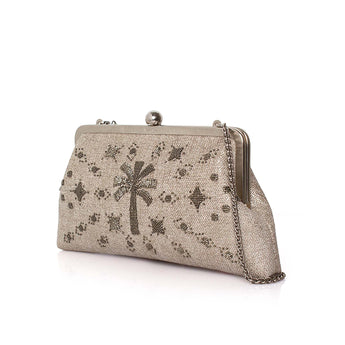 A metallic champagne clutch bag with a silver-tone kiss-lock frame, chain strap, and an all-over beaded star and palm tree pattern, shown on a white background.