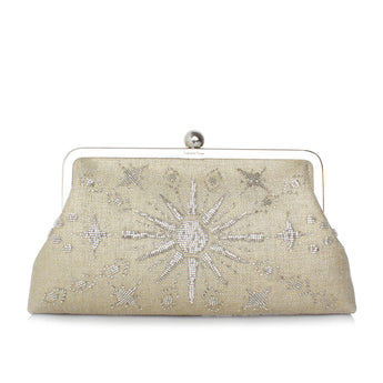 A gold clutch bag with a metallic sun and stars pattern, and a silver clasp.
