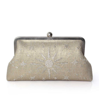 A gold clutch bag with a metallic sun and stars pattern, and a silver clasp.