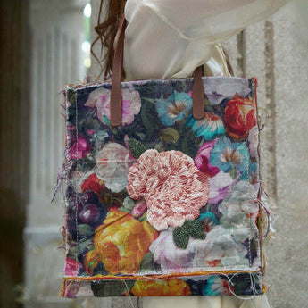 Floral patterned tote bag with brown handles on model