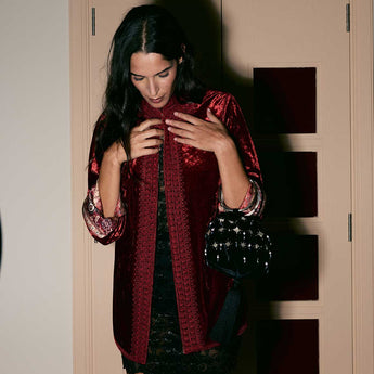 Model wearing the Ruby Velvet Casa Jacket, ruby red velvet jacket