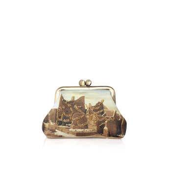 A small bag clutch bag with a vintage-style printed illustration of figures and warm lights, framed in gold-tone metal on a white background.