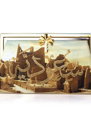 A hand-beaded clutch with a depiction of a historic city and the text 'Saoudiah'.