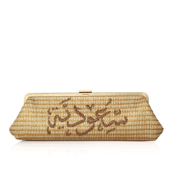 A woven straw clutch bag with gold-tone metal hardware and Arabic calligraphy embellishments in brown beads on the front, set against a plain white background.