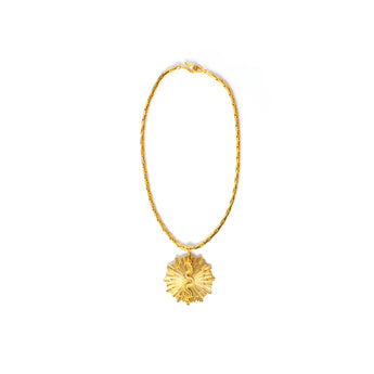 A gold-colored necklace with a floral-shaped pendant.