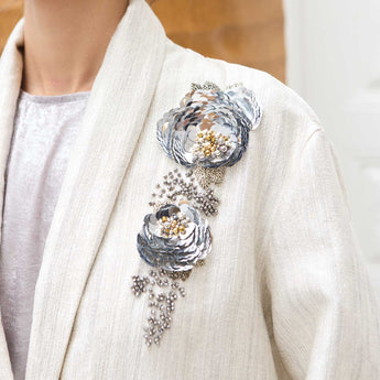 Decorative beaded floral design on a white cover up